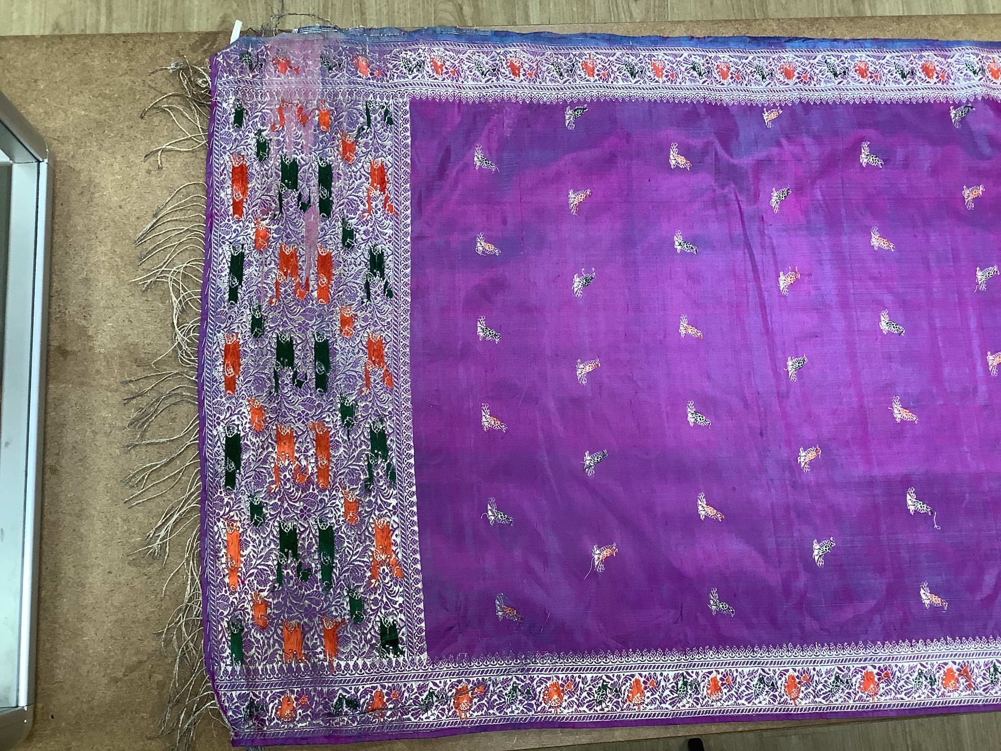 A Chinese embroidered silk panel of a phoenix, 84.5 x 54 cm, an Indian silk panel and a metal beadwork purse